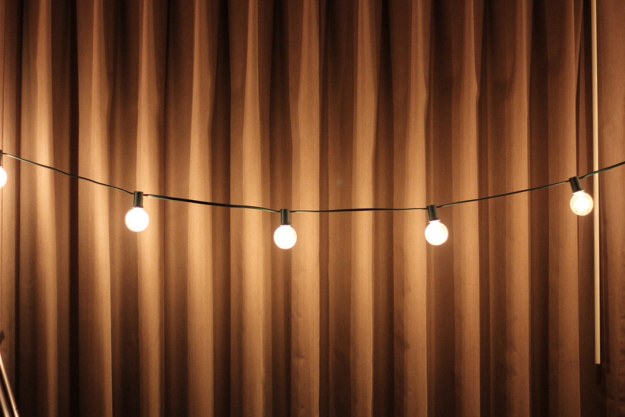 Black String Lights Beside Brown Curtain